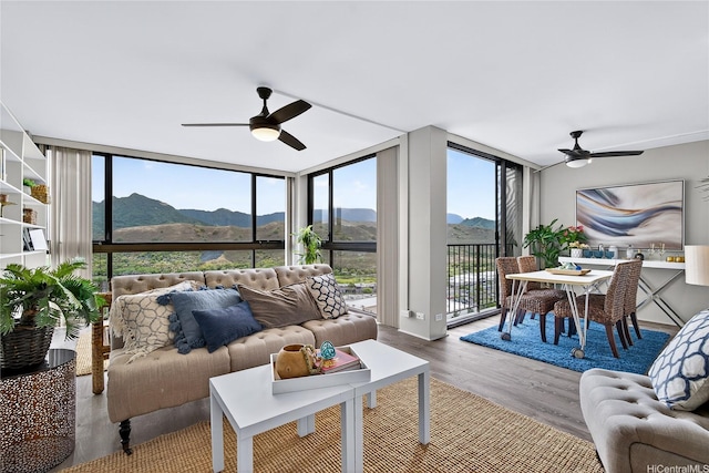 322 Aoloa St Unit 1708, Kailua, HI 96734 - living room featuring a wall of windows, a ceiling fan, a mountain view, and wood finished floors