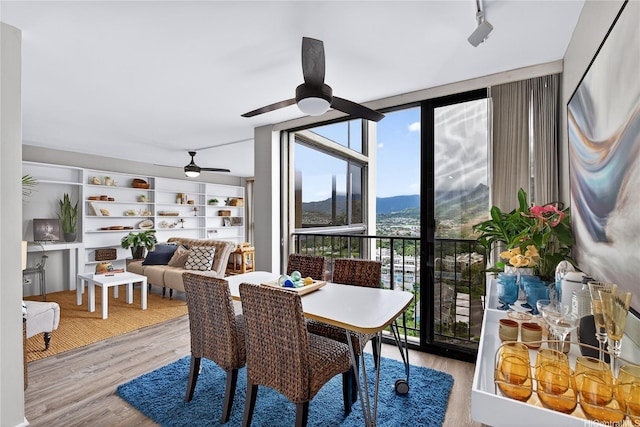 322 Aoloa St Unit 1708, Kailua, HI 96734 - dining area featuring expansive windows, a ceiling fan, a mountain view, and wood finished floors