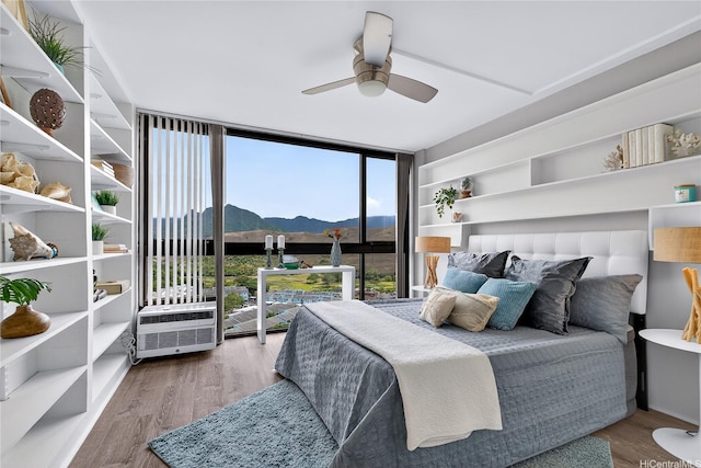 322 Aoloa St Unit 1708, Kailua, HI 96734 - bedroom featuring a wall of windows, a mountain view, wood finished floors, and ceiling fan