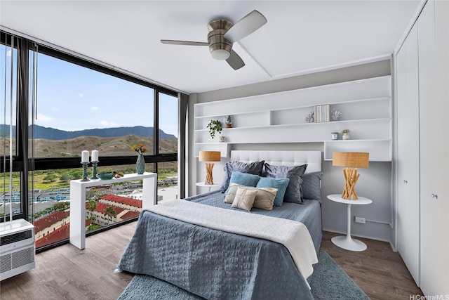 322 Aoloa St Unit 1708, Kailua, HI 96734 - bedroom featuring a wall of windows, a mountain view, wood finished floors, and a ceiling fan