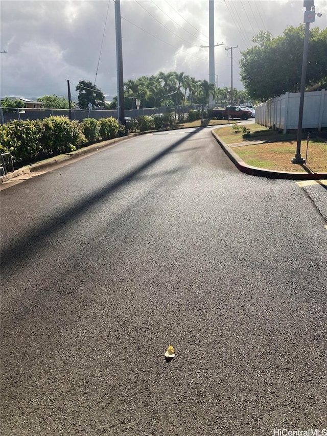 4280 Salt Lake Blvd Unit C13, Honolulu, HI 96818 - view of asphalt road featuring curbs and street lights