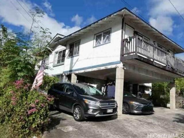 1731 Aupuni St Unit 1, Honolulu, HI 96817 - view of home's exterior featuring a carport and asphalt driveway
