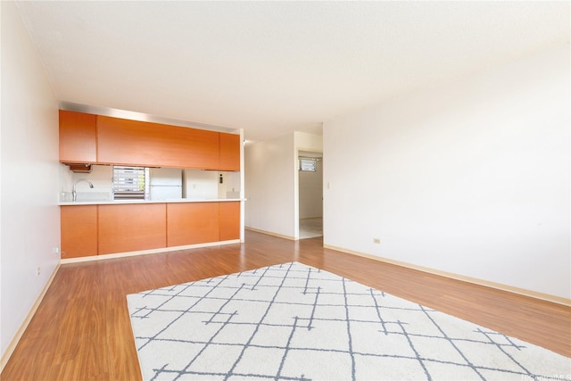 3030 Ala Ilima St Unit 402, Honolulu, HI 96818 - kitchen with freestanding refrigerator, wood finished floors, open floor plan, and light countertops