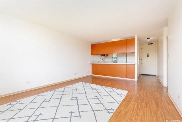 3030 Ala Ilima St Unit 402, Honolulu, HI 96818 - unfurnished living room featuring light wood finished floors and baseboards