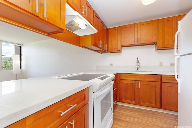 3030 Ala Ilima St Unit 402, Honolulu, HI 96818 - kitchen with white appliances, under cabinet range hood, brown cabinets, and light wood-type flooring