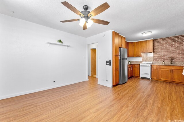 1210 Wilder Ave Unit 305, Honolulu, HI 96822 - kitchen with freestanding refrigerator, white range, light wood finished floors, brown cabinets, and a textured ceiling