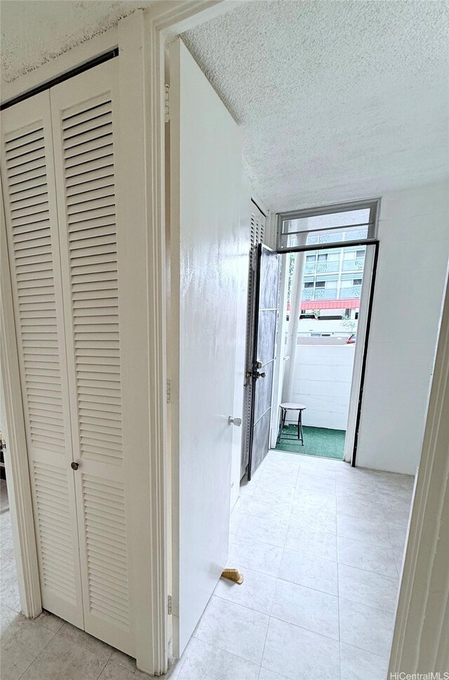 751 Kinau St Unit Dh20, Honolulu, HI 96813 - hallway featuring a textured ceiling and light tile patterned flooring