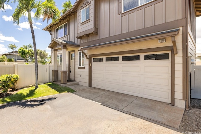 91-1221 Kanela St Unit M54, Ewa Beach, HI 96706 - view of front facade with board and batten siding, an attached garage, and concrete driveway