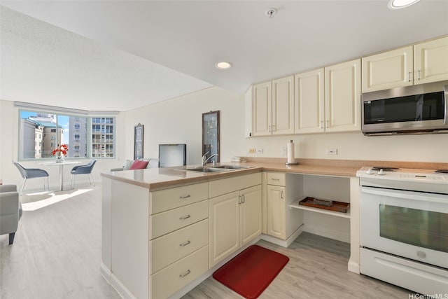 1314 Kalakaua Ave Unit 1407, Honolulu, HI 96826 - kitchen with stainless steel microwave, white electric stove, cream cabinetry, light wood-style floors, and a peninsula