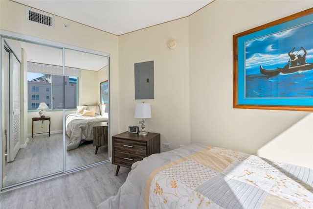1314 Kalakaua Ave Unit 1407, Honolulu, HI 96826 - bedroom with electric panel, wood finished floors, and a closet