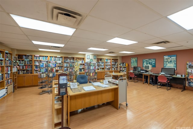 1314 Kalakaua Ave Unit 1407, Honolulu, HI 96826 - home office with light wood-style flooring, a paneled ceiling, and bookshelves