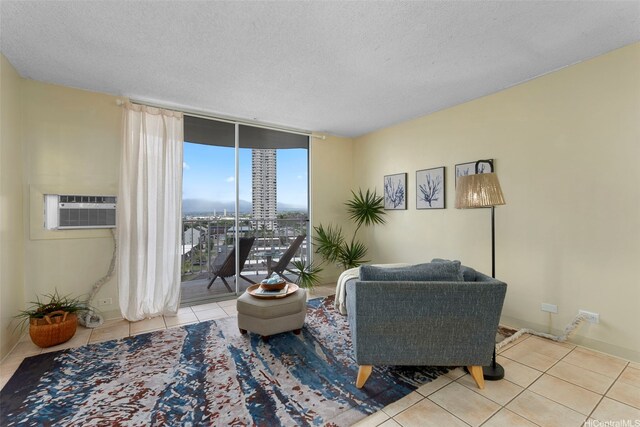 98-1038 Moanalua Rd Unit 1502, Aiea, HI 96701 - sitting room with tile patterned floors, a wall unit AC, a textured ceiling, and floor to ceiling windows