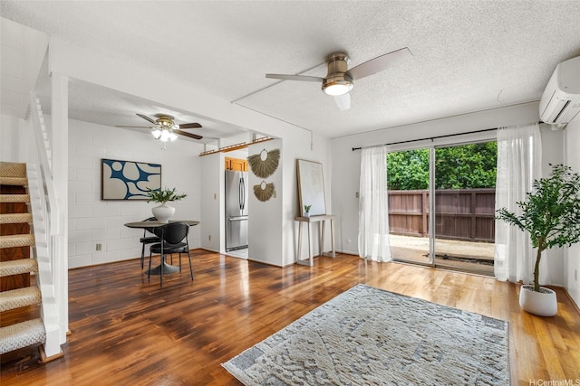 95-45 Hokuiwa St Unit 22, Mililani, HI 96789 - living room with a ceiling fan, stairway, an AC wall unit, wood finished floors, and a textured ceiling