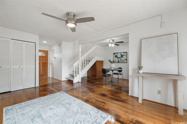 95-45 Hokuiwa St Unit 22, Mililani, HI 96789 - living area featuring ceiling fan, stairs, wood finished floors, and a textured ceiling