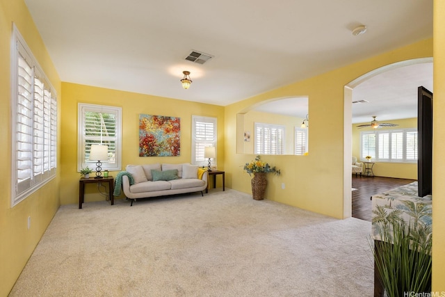 91-1009 Kaianae St, Ewa Beach, HI 96706 - living area with carpet floors, arched walkways, and a ceiling fan