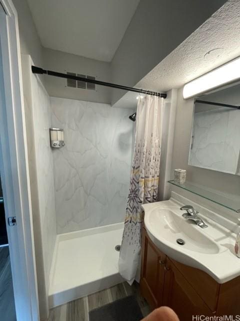 2450 Koa Ave Unit 35, Honolulu, HI 96815 - full bathroom featuring vanity, wood finished floors, and a shower stall