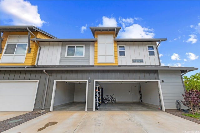 91-3475 Nana Hope St Unit 601, Ewa Beach, HI 96706 - back of house featuring an attached garage, concrete driveway, and board and batten siding