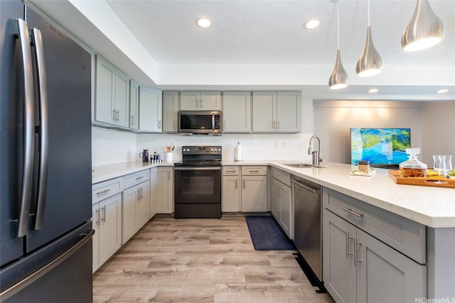 5216 Hao Pl, Honolulu, HI 96821 - kitchen with stainless steel appliances, a peninsula, recessed lighting, light countertops, and light wood-type flooring