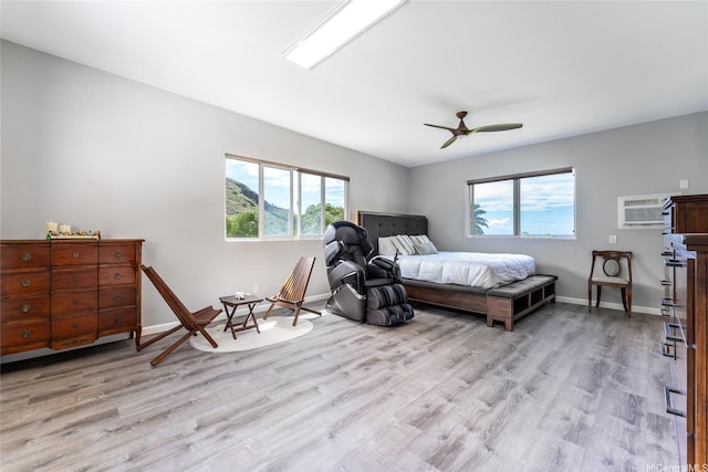 5216 Hao Pl, Honolulu, HI 96821 - bedroom with multiple windows, light wood-type flooring, and an AC wall unit