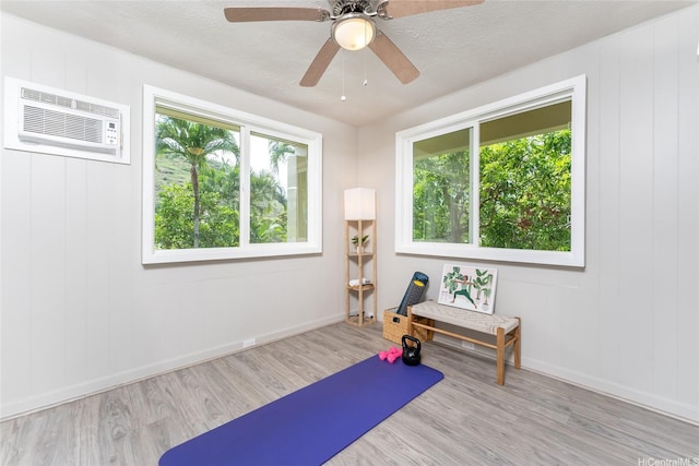 5216 Hao Pl, Honolulu, HI 96821 - exercise area featuring wood finished floors, ceiling fan, and a wall mounted air conditioner