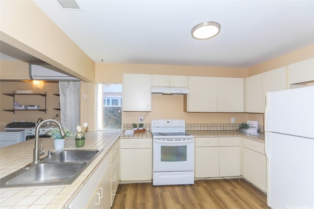 753 Kalanipuu St, Honolulu, HI 96825 - kitchen featuring white appliances, under cabinet range hood, independent washer and dryer, wood finished floors, and tile counters