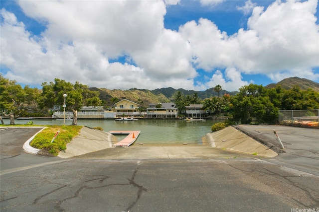 753 Kalanipuu St, Honolulu, HI 96825 - water view featuring a boat ramp, a mountain backdrop, and a boat dock