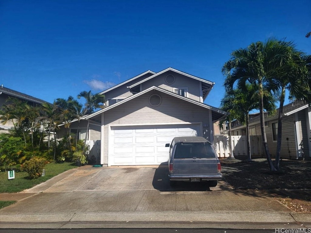 91-1197 Kamoawa St, Ewa Beach, HI 96706 - view of front of house with driveway and an attached garage