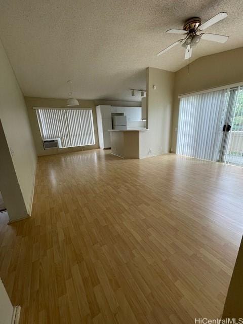 91-1020 Laaulu St Unit 27C, Ewa Beach, HI 96706 - unfurnished living room with a ceiling fan, a textured ceiling, and light wood-style floors