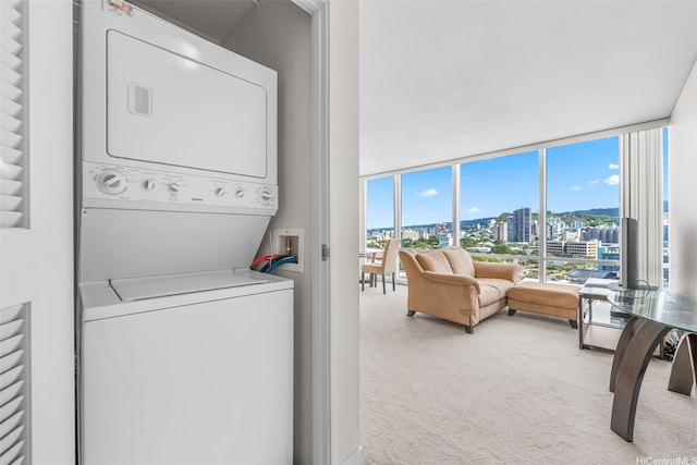 1296 Kapiolani Blvd Unit Ii-1801, Honolulu, HI 96814 - laundry area featuring stacked washer / drying machine and carpet floors