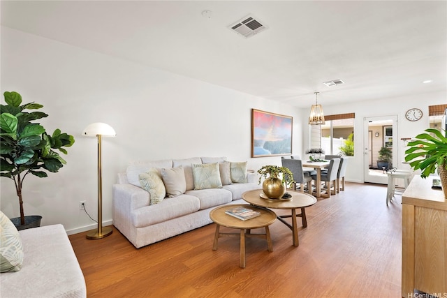91-1312 Keoneula Blvd Unit 203, Ewa Beach, HI 96706 - living area featuring light wood-type flooring and a chandelier
