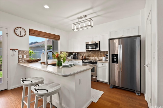 91-1312 Keoneula Blvd Unit 203, Ewa Beach, HI 96706 - kitchen with appliances with stainless steel finishes, decorative backsplash, light countertops, white cabinets, and recessed lighting