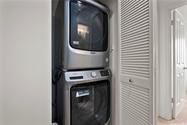 91-1312 Keoneula Blvd Unit 203, Ewa Beach, HI 96706 - laundry room with stacked washing machine and dryer and carpet