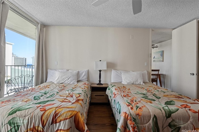 364 Seaside Ave Unit 1211, Honolulu, HI 96815 - bedroom featuring a textured ceiling, access to outside, wood finished floors, and ceiling fan