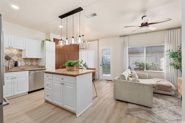 91-1021 Kaileolea Dr Unit H3, Ewa Beach, HI 96706 - kitchen featuring dishwasher, light wood-style flooring, backsplash, white cabinetry, and open floor plan