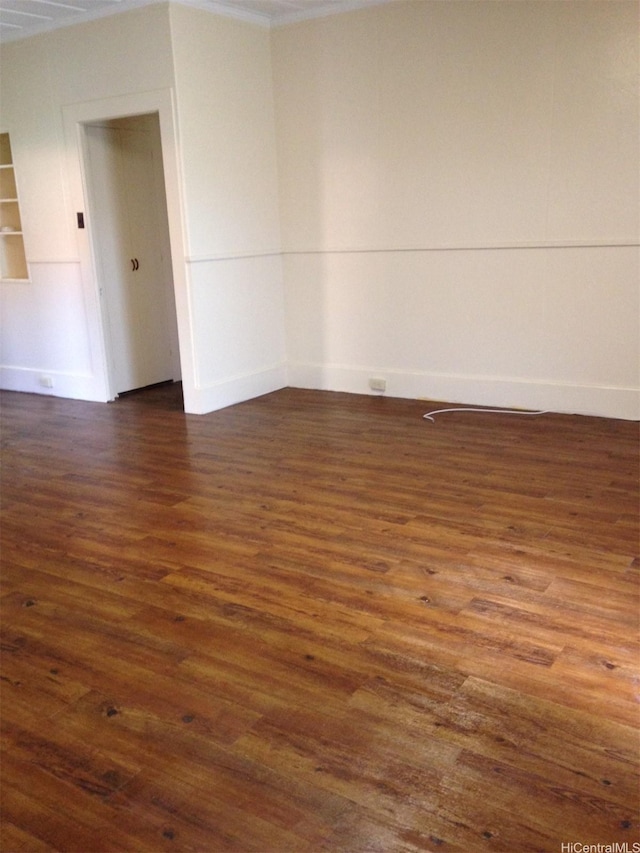 spare room with dark wood-type flooring