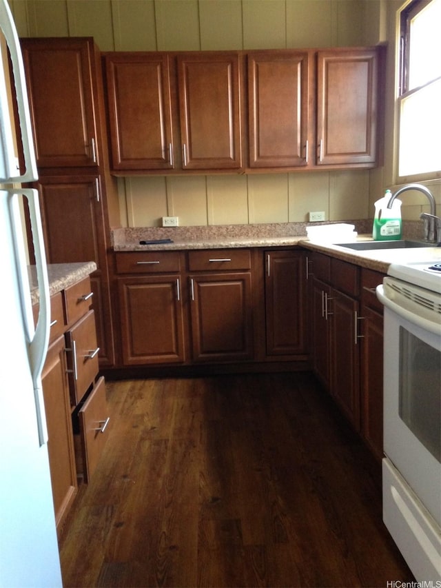 kitchen with white appliances and dark wood-style floors