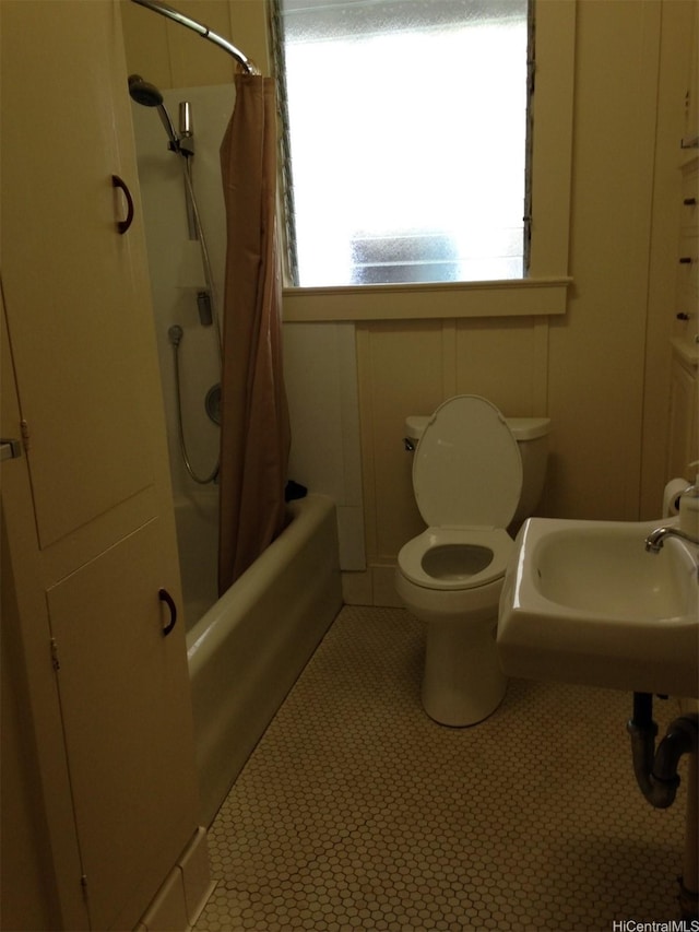 full bathroom featuring shower / bath combination with curtain and tile patterned flooring