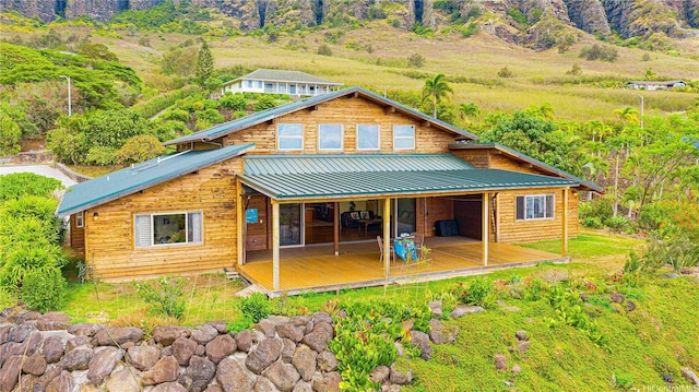 84-1369 Maunaolu St, Waianae, HI 96792 - back of property with a deck and a metal roof