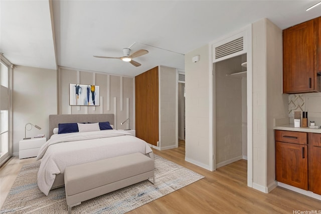 445 Kaiolu St Unit 401, Honolulu, HI 96815 - bedroom with light wood-style flooring and a ceiling fan