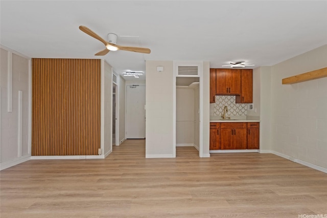 445 Kaiolu St Unit 401, Honolulu, HI 96815 - kitchen featuring light wood-style floors, ceiling fan, brown cabinets, and light countertops