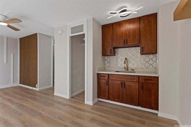 445 Kaiolu St Unit 401, Honolulu, HI 96815 - kitchen featuring a ceiling fan, light countertops, light wood finished floors, and decorative backsplash