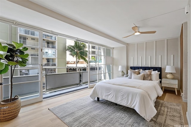 445 Kaiolu St Unit 401, Honolulu, HI 96815 - bedroom with wood finished floors, ceiling fan, and access to exterior