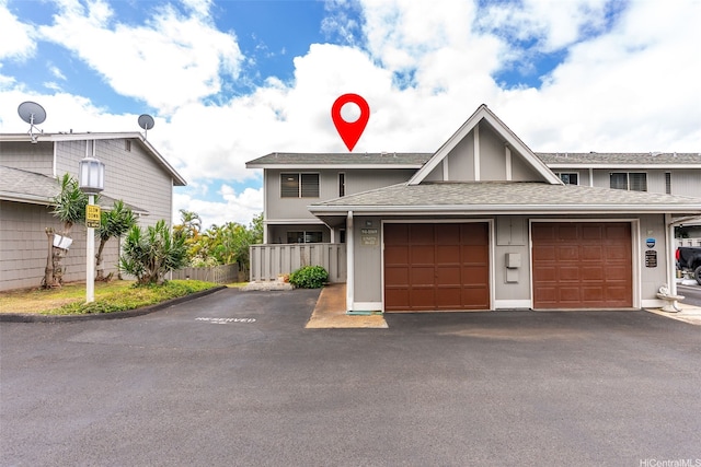 94-1069 Anania Cir Unit 16, Mililani, HI 96789 - view of property featuring a shingled roof, driveway, and a garage