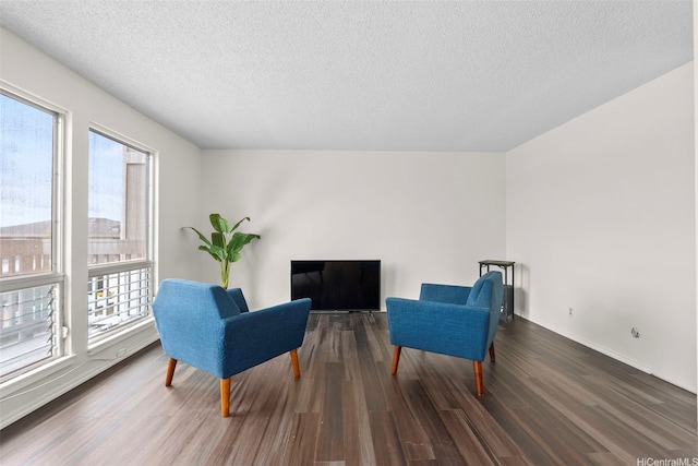 94-1069 Anania Cir Unit 16, Mililani, HI 96789 - living area featuring plenty of natural light, dark wood-style floors, and a textured ceiling