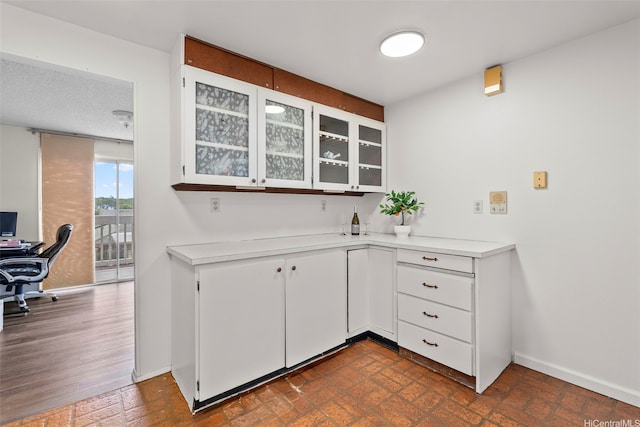 94-1069 Anania Cir Unit 16, Mililani, HI 96789 - kitchen with light countertops, an office area, white cabinets, and glass insert cabinets