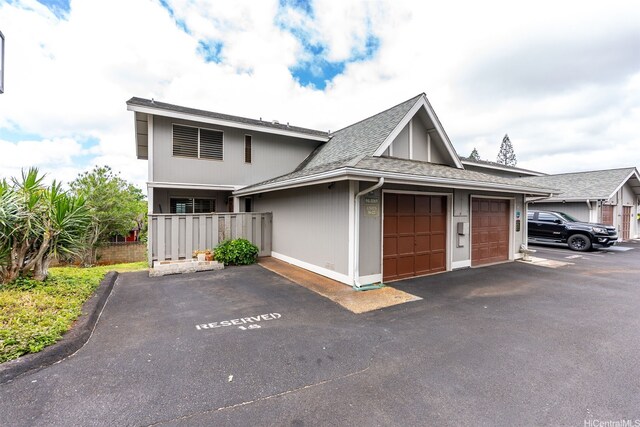 94-1069 Anania Cir Unit 16, Mililani, HI 96789 - view of front of property with a shingled roof, an attached garage, and driveway