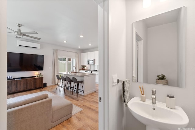 91-1641 Honouliuli St Unit 42, Ewa Beach, HI 96706 - bathroom featuring a wall mounted AC, a ceiling fan, wood finished floors, and recessed lighting