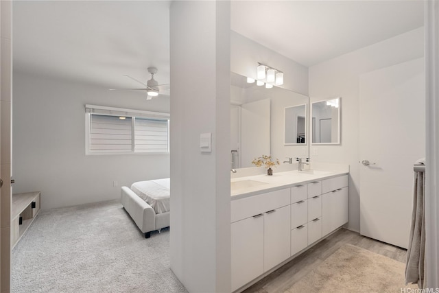 91-1641 Honouliuli St Unit 42, Ewa Beach, HI 96706 - bathroom with double vanity, connected bathroom, ceiling fan, and wood finished floors