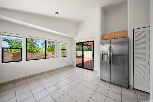 91-1517 Wahane St, Kapolei, HI 96707 - kitchen with stainless steel refrigerator with ice dispenser, a towering ceiling, light tile patterned flooring, and light brown cabinetry