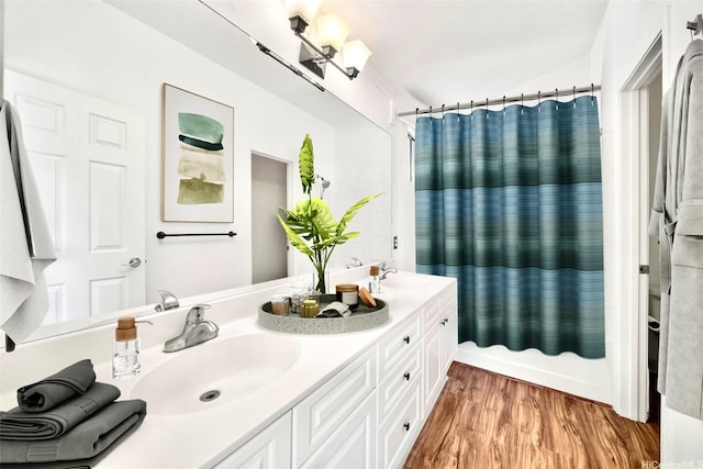 91-1517 Wahane St, Kapolei, HI 96707 - full bath with double vanity, wood finished floors, and shower / bathtub combination with curtain
